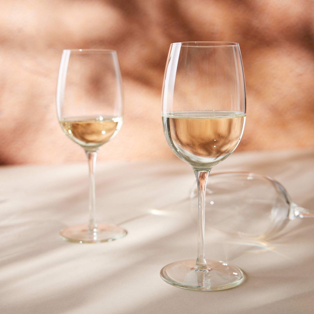 Slender profile of white wine glass enhances aromas and flavors; stable, ergonomic, and balanced base helps prevent tipping